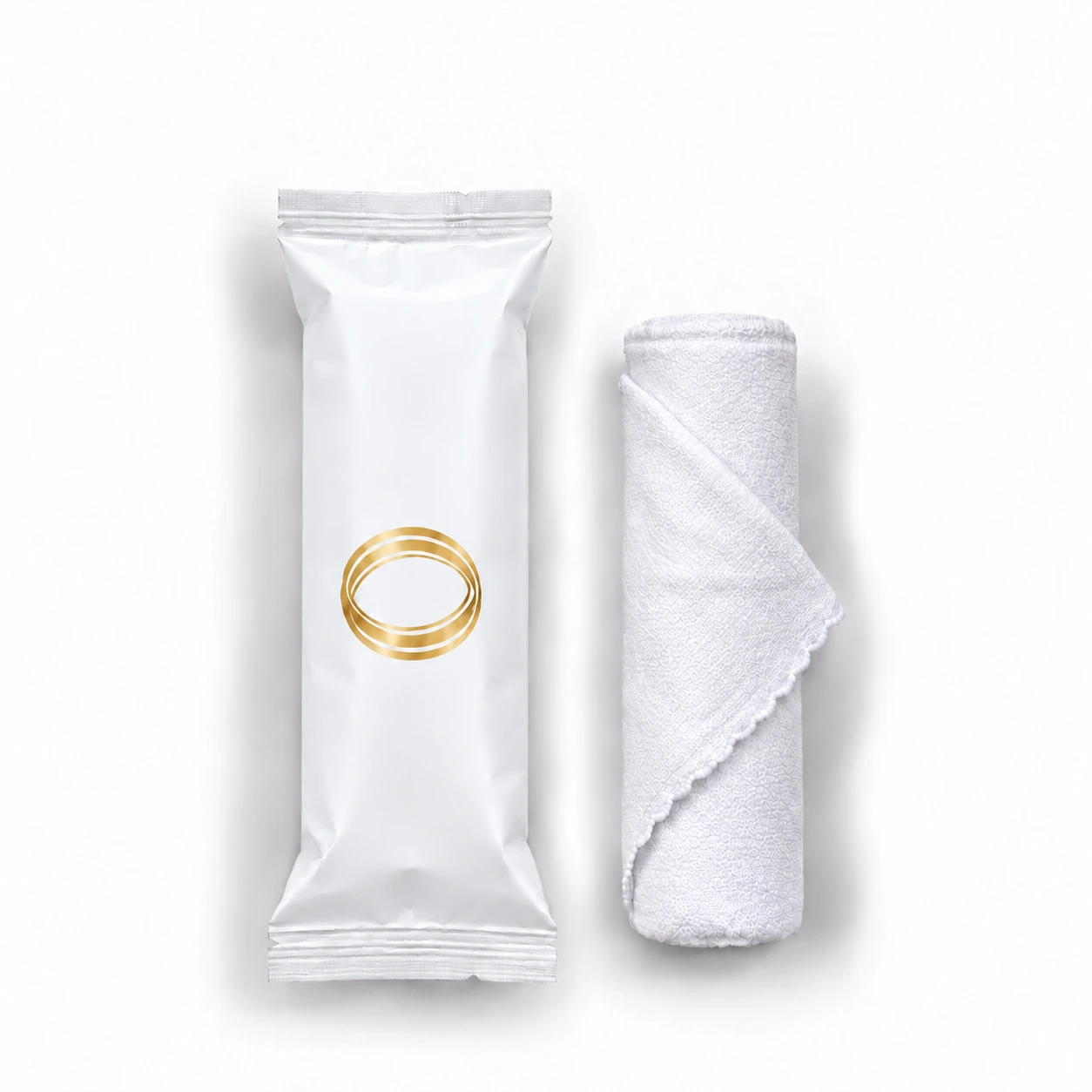 White Tea oshibori towel in matte white packaging, shown upright beside the rolled white microfiber towel