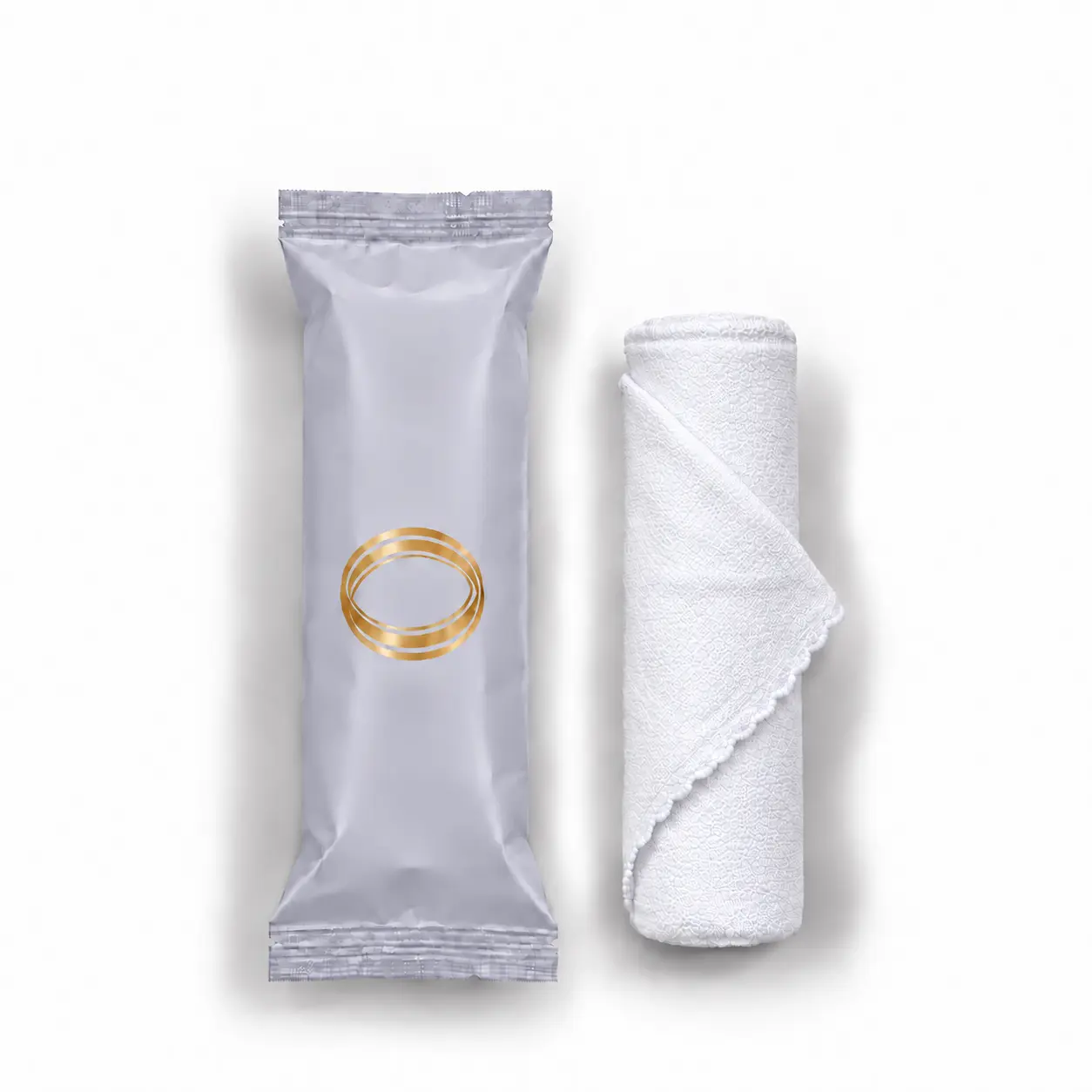 Lavender oshibori towel in light lilac packaging, shown upright beside the rolled white microfiber towel